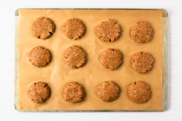 unbaked chia almond protein cookies on a parchment-lined baking tray.