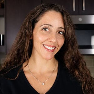 smiling woman in kitchen.