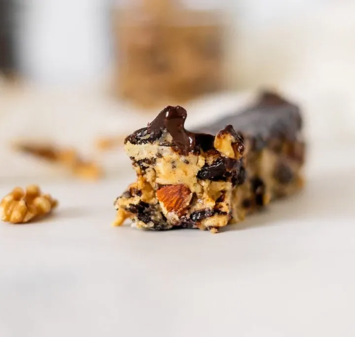 close up of a fruit and nut bar on a plate.