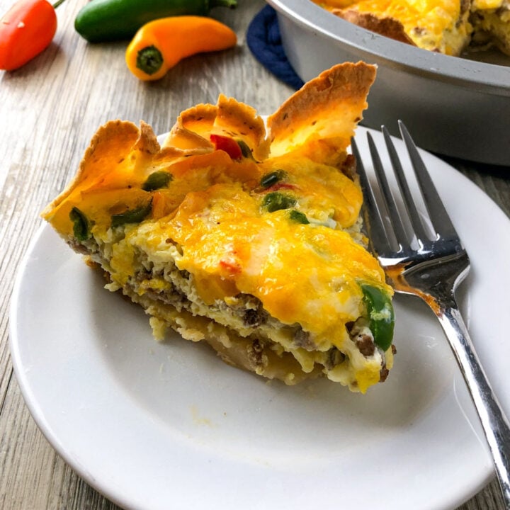 a slice of southwest sausage quiche with melted cheese on top.