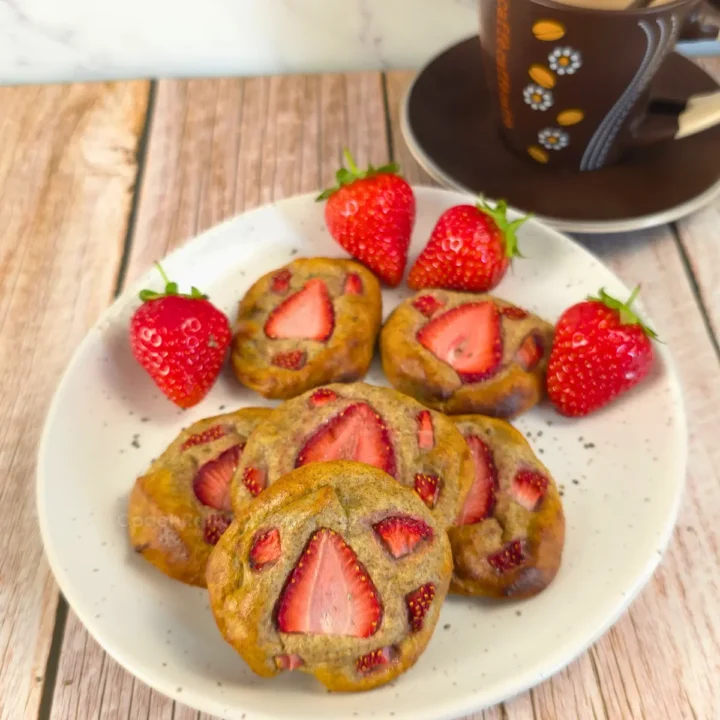 Delicious protein strawberry bites topped with strawberries, served with a coffee.