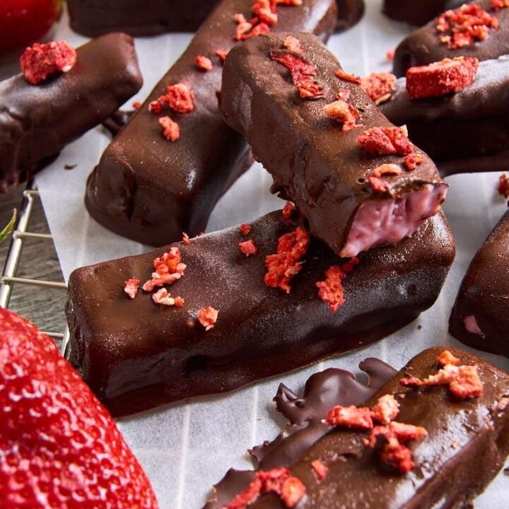 Delicious high-protein chocolate bars topped with crushed strawberries for a healthy snack.