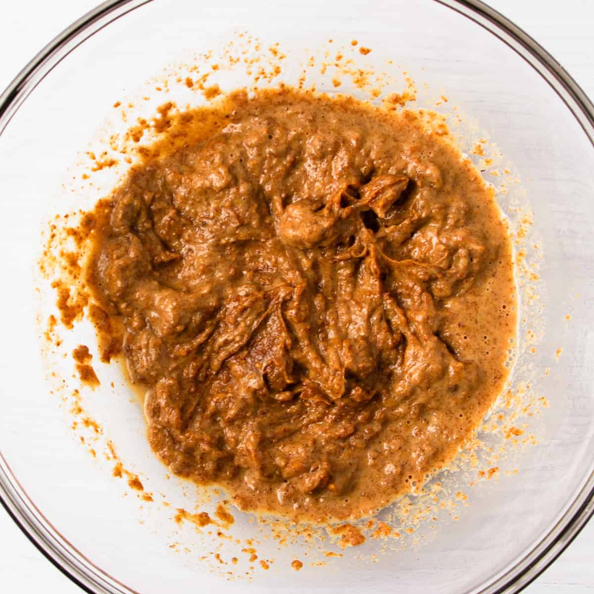 almond butter mixed with water and vanilla in a glass bowl.