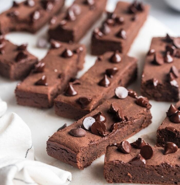 chocolate protein bars with chocolate chips on a plate.
