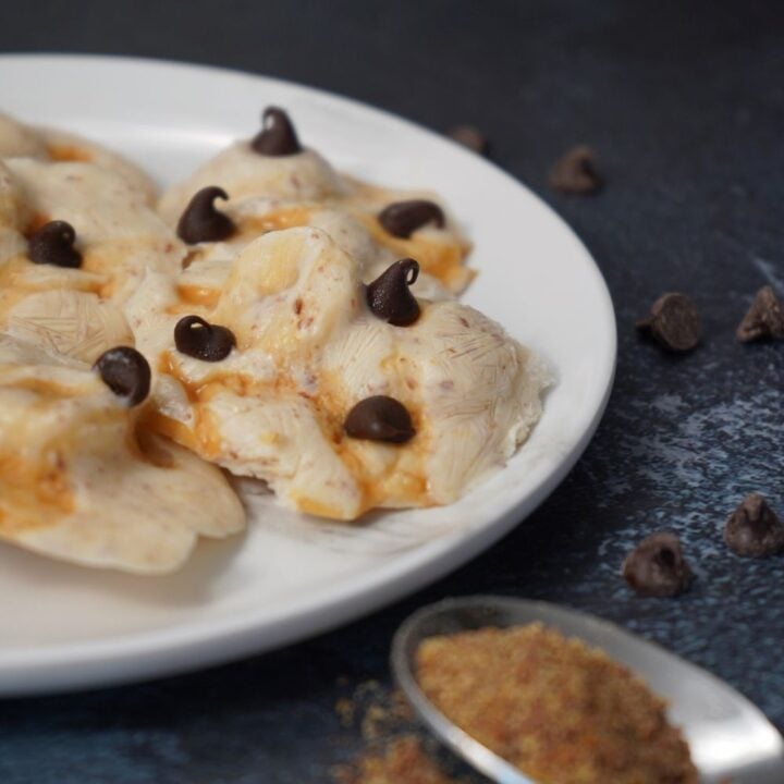 frozen banana yogurt clusters with chocolate chips on a plate.