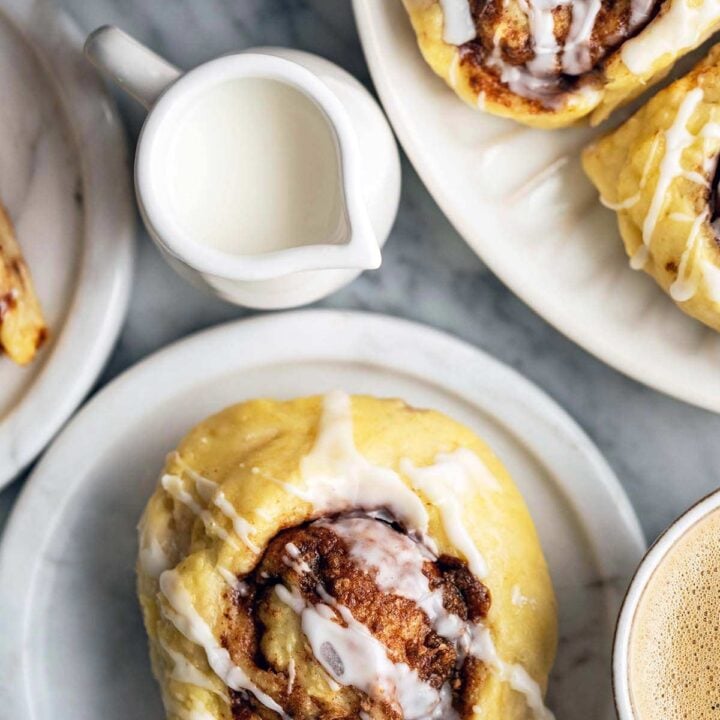 Delicious protein pastries topped with creamy icing, served with coffee for a nutritious breakfast.