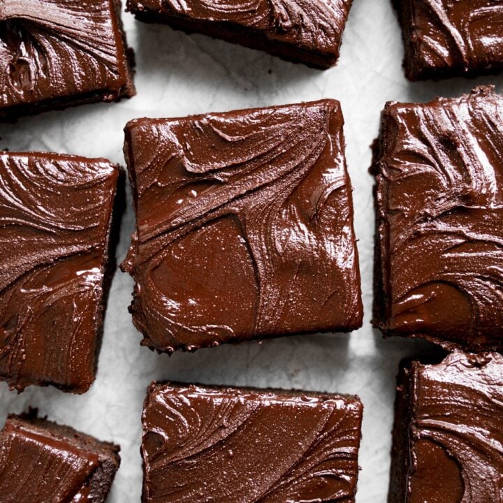 Delicious protein brownies topped with rich chocolate frosting, perfect for healthy snacks and workout recovery.