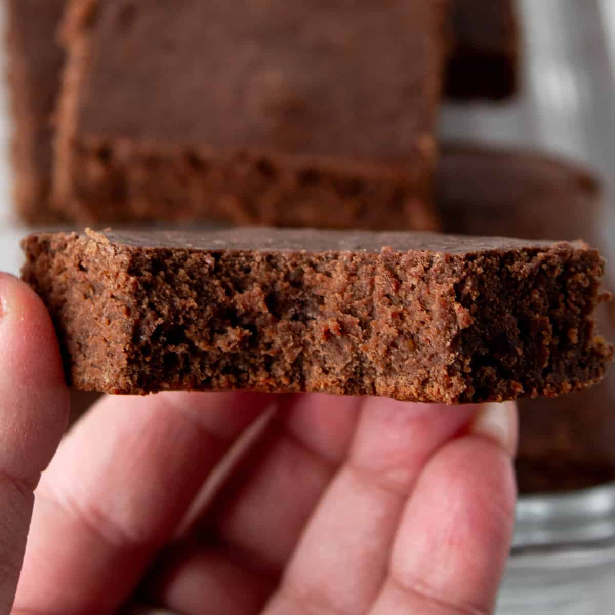 whey protein brownie, bitten, in hand.