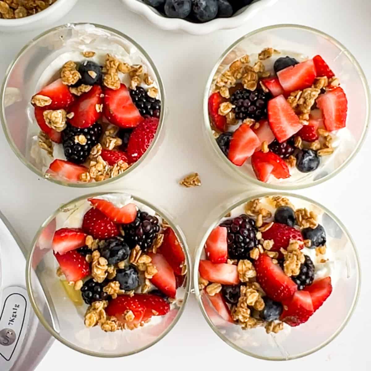 one layer of berry yogurt parfait on four jars.